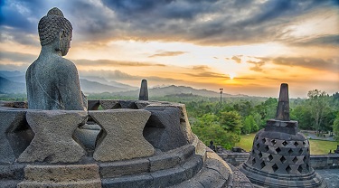 A sunset view of the ancient Borobudur temple complex in Central Java