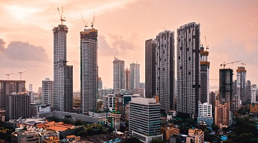The skyline of Mumbai, India, at sunset. Many skyscrapers are under construction. Exporting to India from Canada provides new opportunities for growth. 