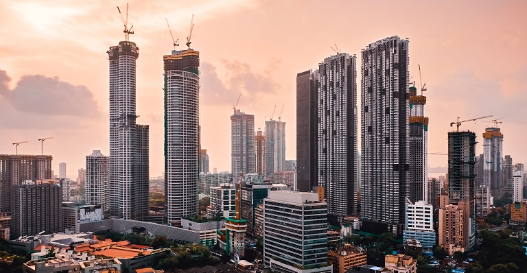The skyline of Mumbai, India, at sunset. Many skyscrapers are under construction. Exporting to India from Canada provides new opportunities for growth. 