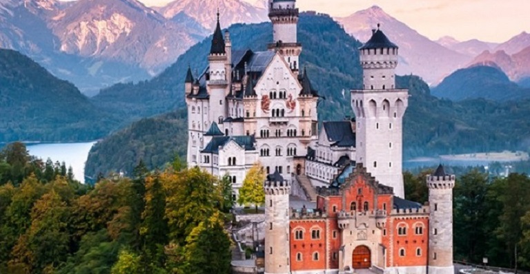 A lush alpine landscape surrounds Germany’s iconic Neuschwanstein Castle