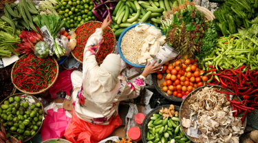 Muslim woman selling fresh vegetables at market in kota baru malaysia