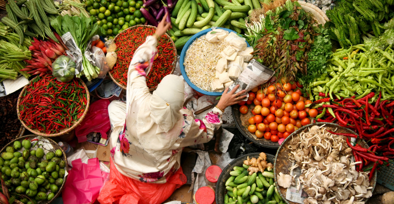 Muslim woman selling fresh vegetables at market in kota baru malaysia