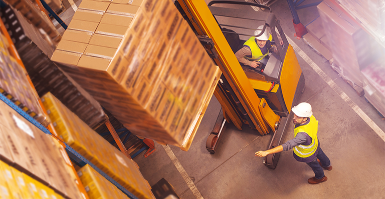 Workers are checking orders on a loading dock