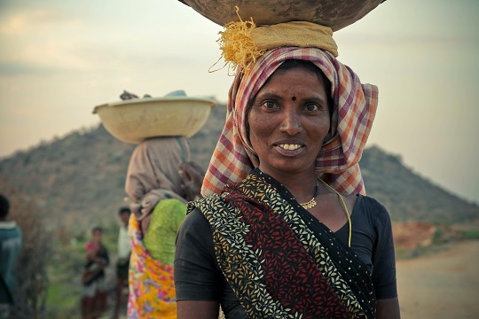 A consumer in the Indian market smiles.