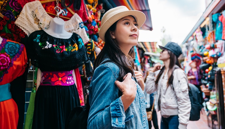 Women wearing masks browse Mexican market