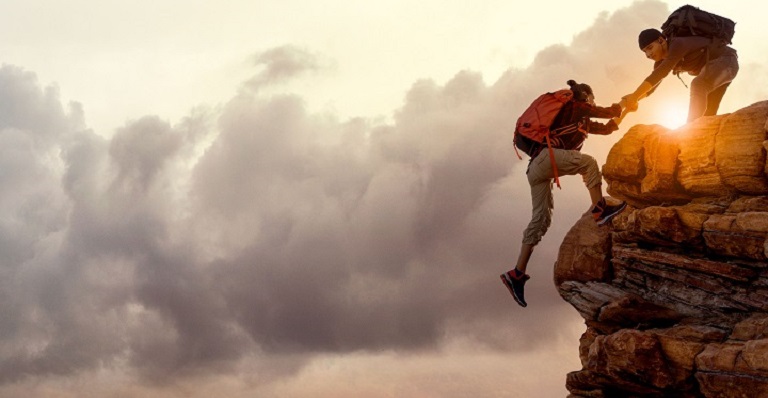 Mountain climbers manage a risky move