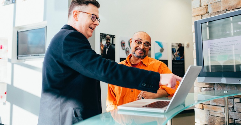 Two main looking at a computer screen